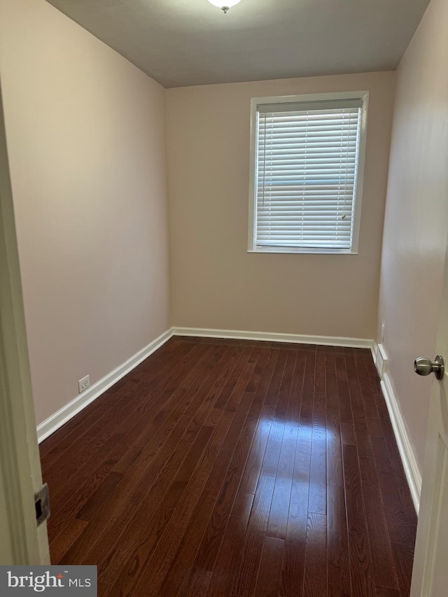 empty room featuring dark wood-type flooring