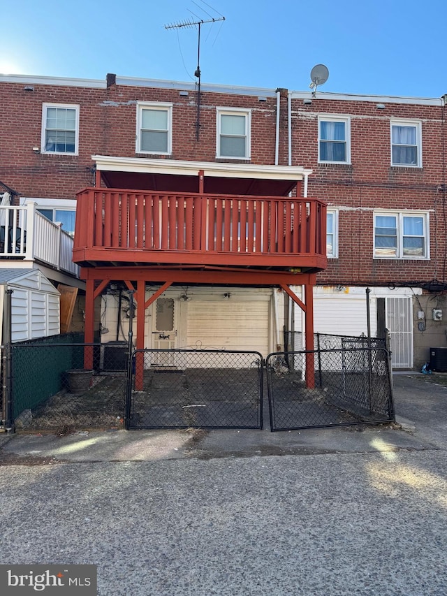 rear view of property featuring a deck