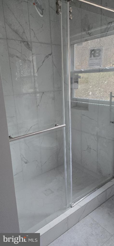 bathroom with a shower with shower door