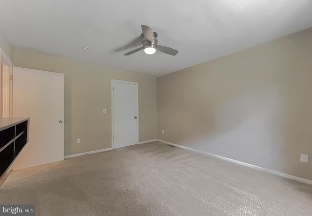 unfurnished bedroom with ceiling fan and light carpet