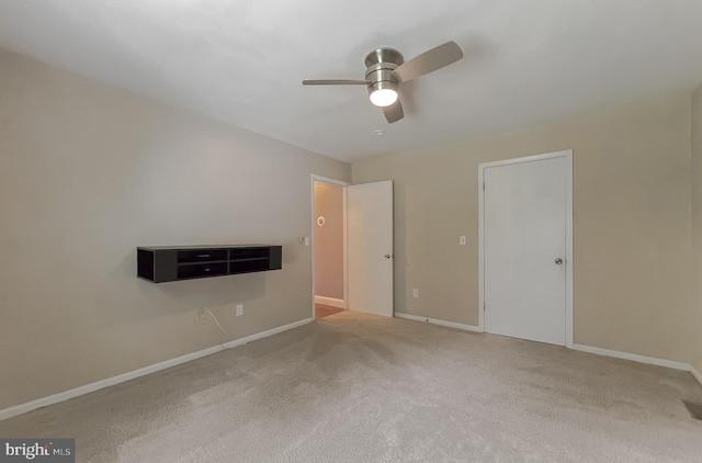 unfurnished room featuring carpet and ceiling fan