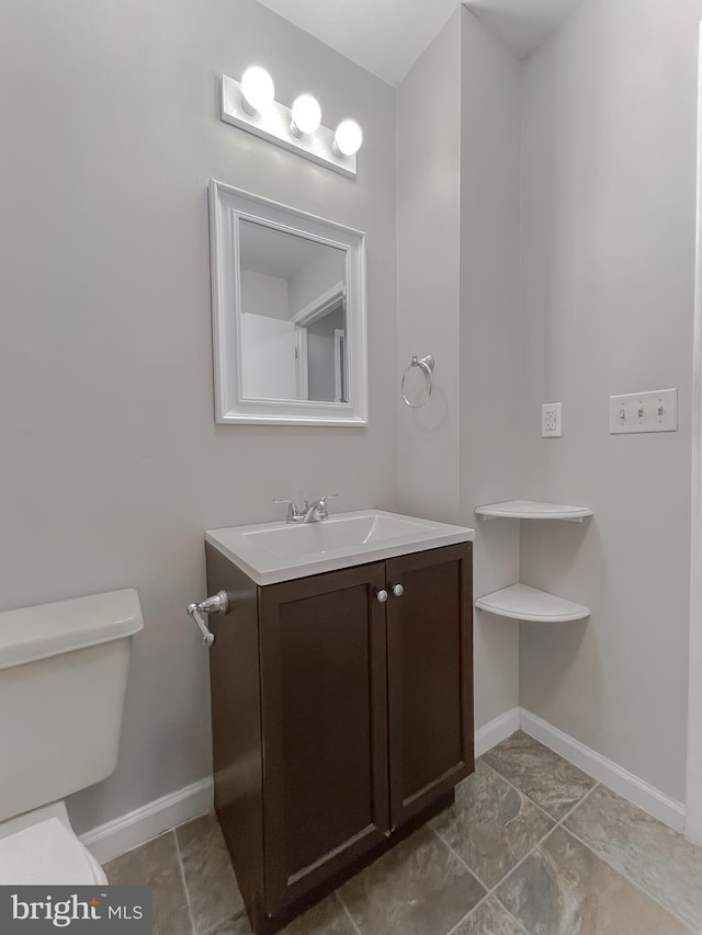 bathroom with toilet and vanity