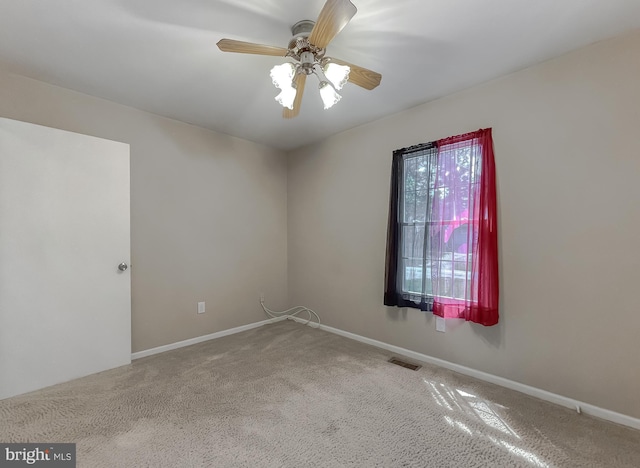 spare room featuring carpet floors and ceiling fan