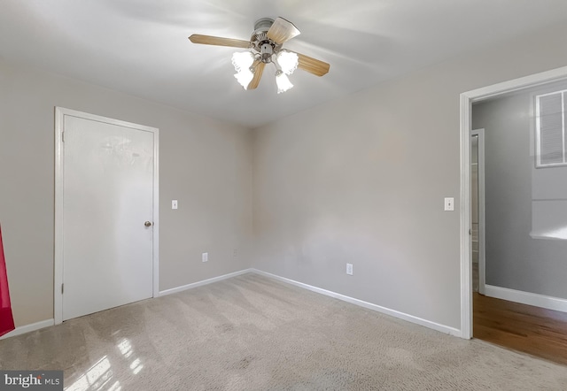 unfurnished bedroom with ceiling fan and light colored carpet