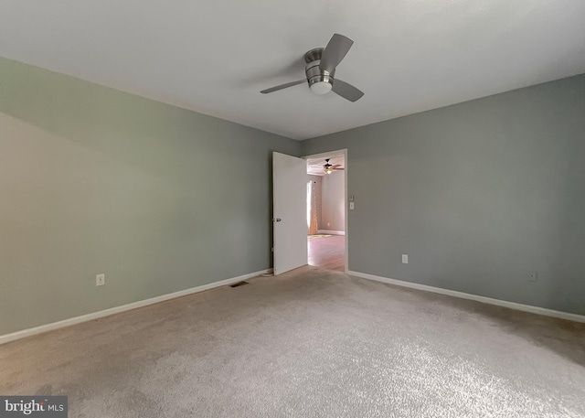 spare room with ceiling fan and carpet flooring