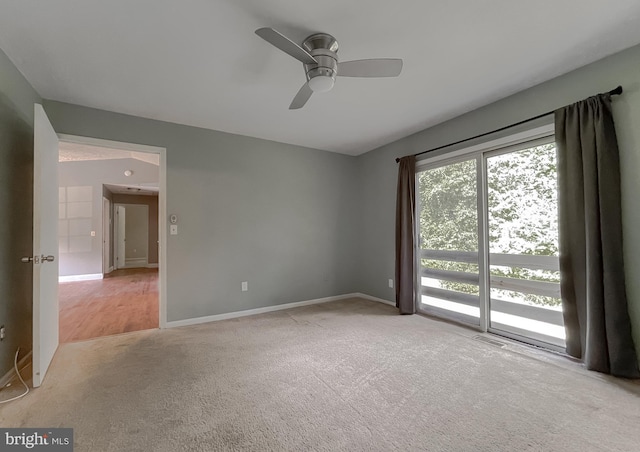 spare room with ceiling fan and light colored carpet