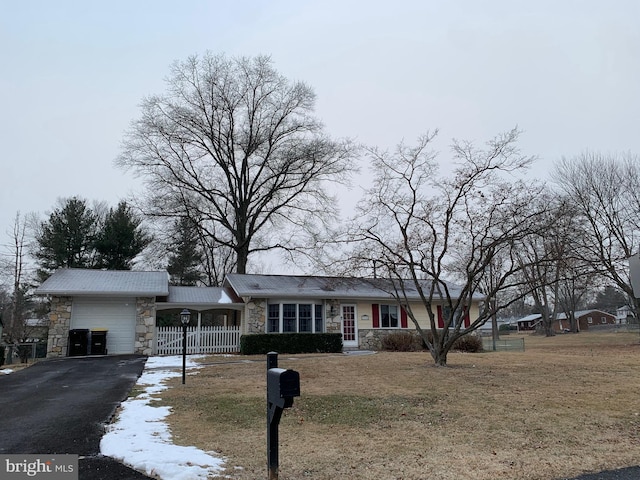 ranch-style home with a front yard and a garage