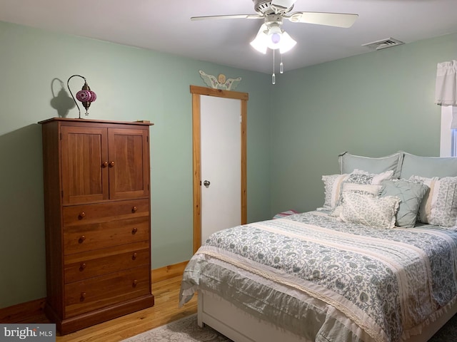 bedroom with ceiling fan and light hardwood / wood-style flooring