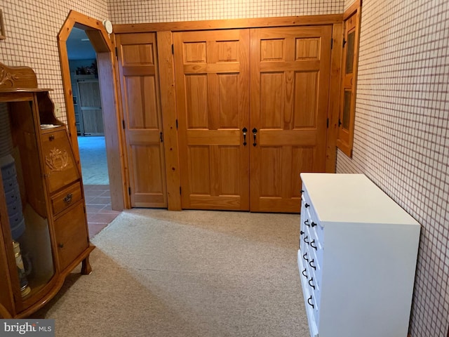 hallway with light colored carpet