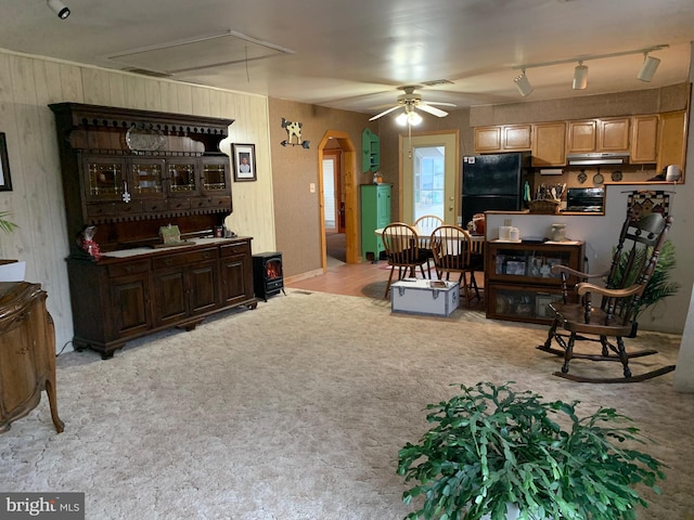 carpeted living room featuring ceiling fan