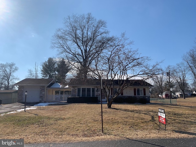 single story home featuring a front yard and a garage