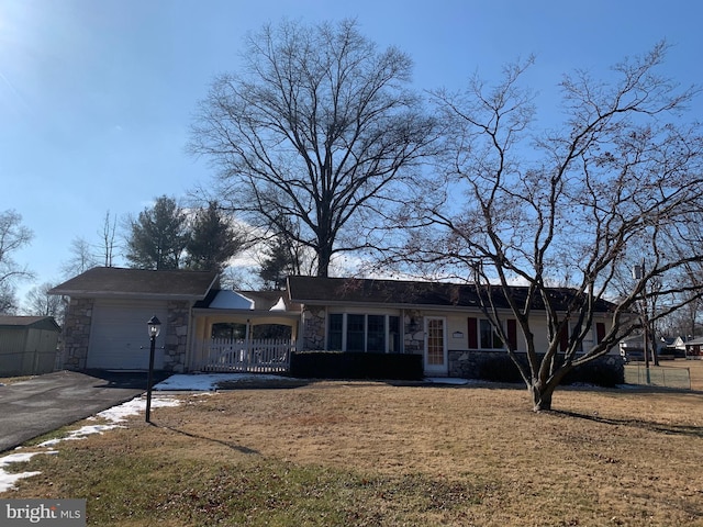 single story home with a front yard and a garage