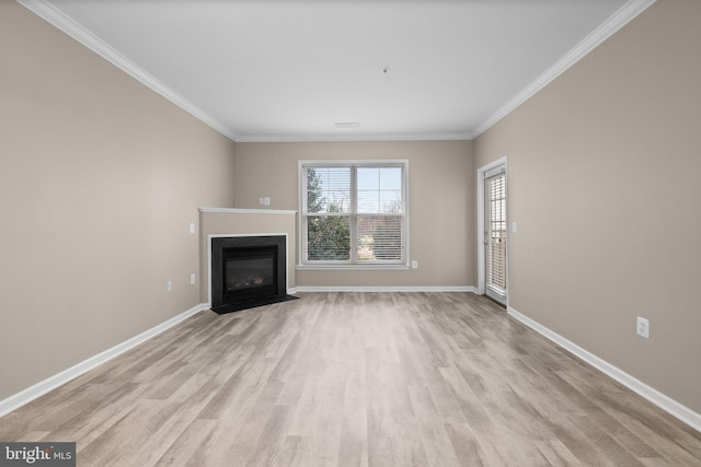 unfurnished living room with ornamental molding and light wood-type flooring