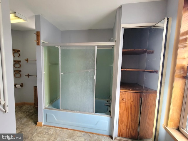 bathroom featuring bath / shower combo with glass door