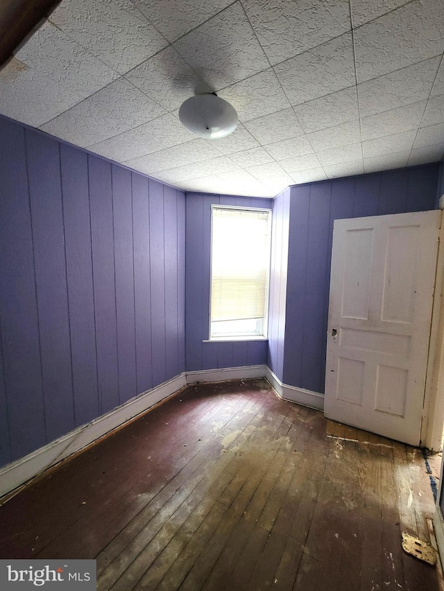 empty room with dark hardwood / wood-style flooring