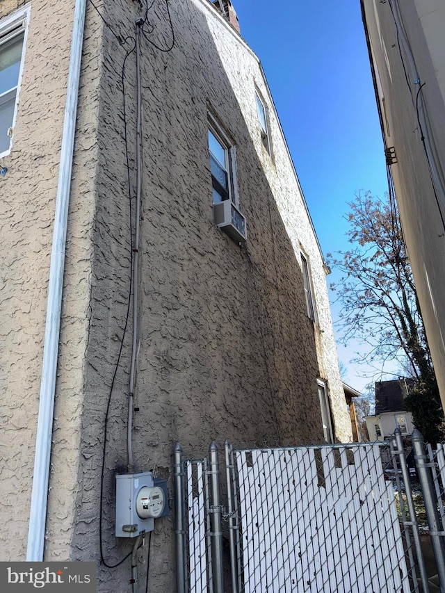 view of side of home featuring cooling unit