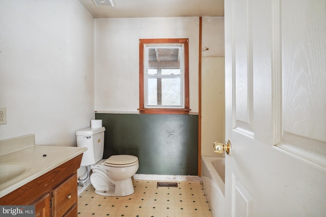 bathroom with a tub, toilet, and vanity