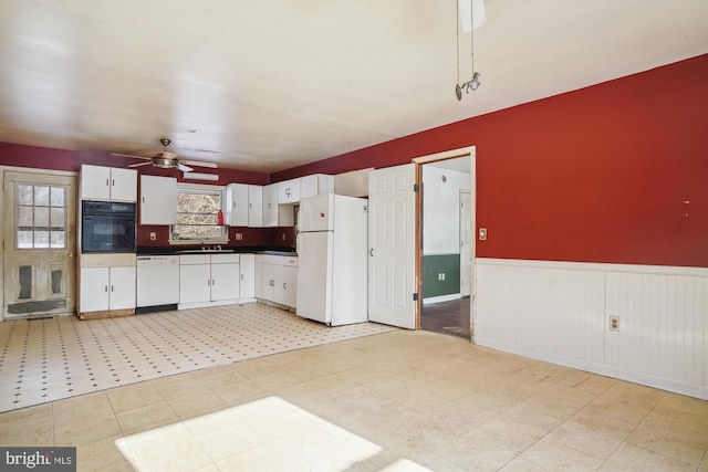 kitchen featuring ceiling fan, white cabinets, sink, and white appliances