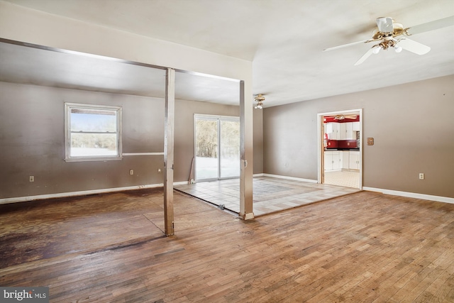 empty room with ceiling fan and hardwood / wood-style floors