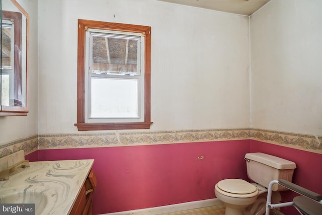 bathroom featuring toilet and vanity