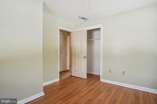 unfurnished bedroom featuring a closet and light wood-type flooring