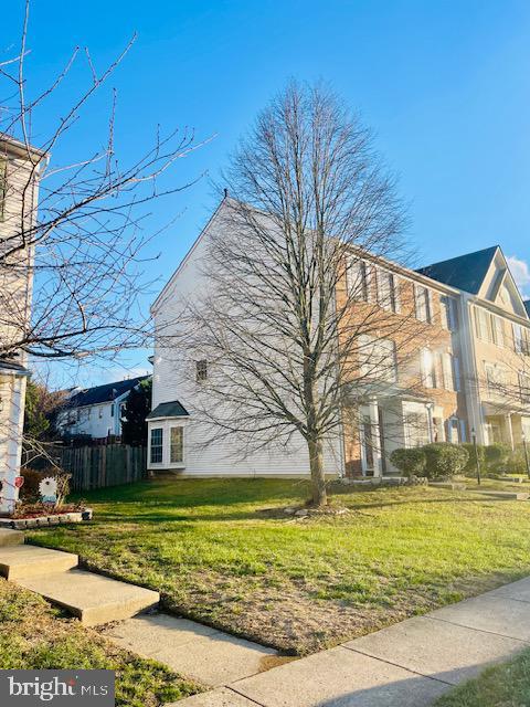 view of side of property with a yard