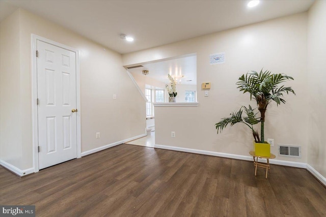 spare room featuring dark hardwood / wood-style flooring