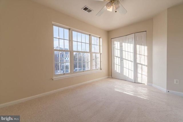 empty room with light carpet and ceiling fan