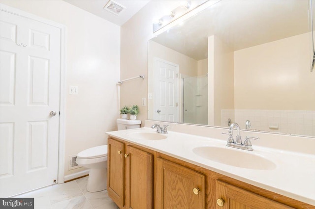 bathroom featuring tile patterned flooring, vanity, and toilet