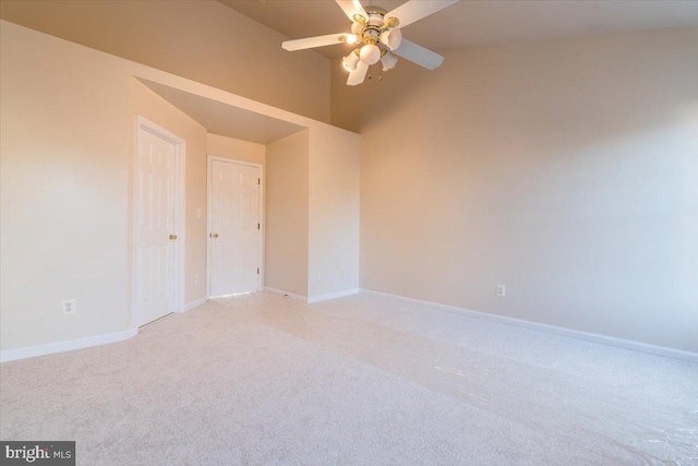 carpeted empty room featuring lofted ceiling and ceiling fan