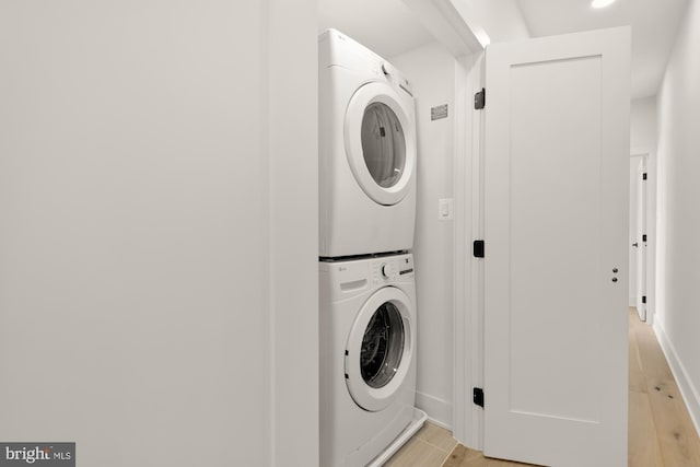 laundry area with stacked washer / dryer