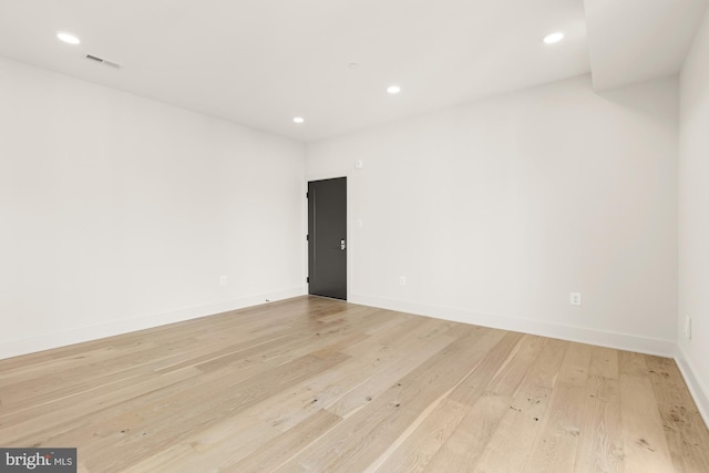 unfurnished room with light hardwood / wood-style floors