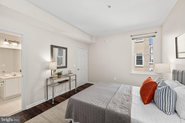 bedroom featuring hardwood / wood-style floors and connected bathroom