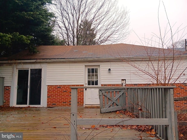 back of property with a wooden deck