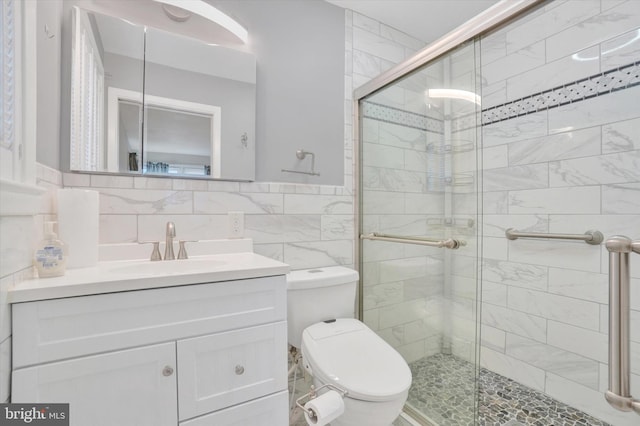 bathroom featuring toilet, decorative backsplash, tile walls, walk in shower, and vanity