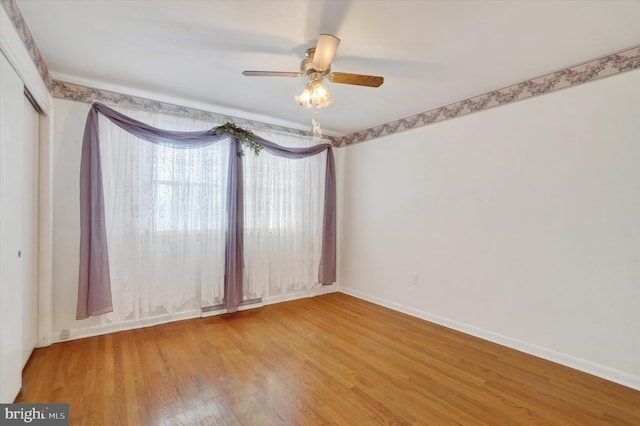 empty room with ceiling fan and hardwood / wood-style flooring