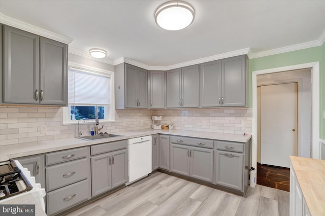 kitchen featuring decorative backsplash, dishwasher, and sink