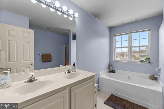 bathroom featuring vanity, a tub, and tile patterned floors