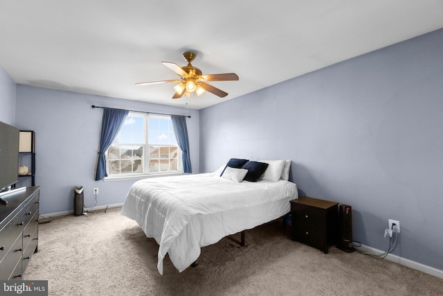 bedroom featuring ceiling fan and light carpet