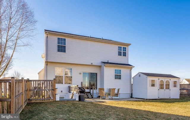 back of house with a yard, a patio, and a storage unit