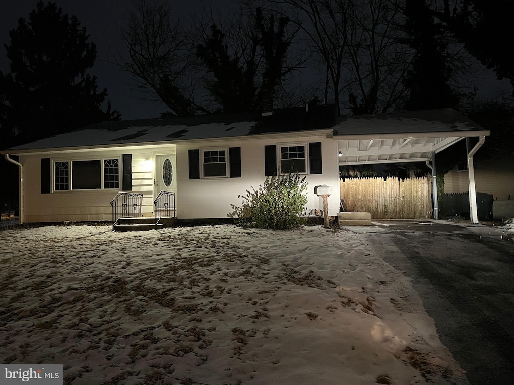 single story home featuring a carport