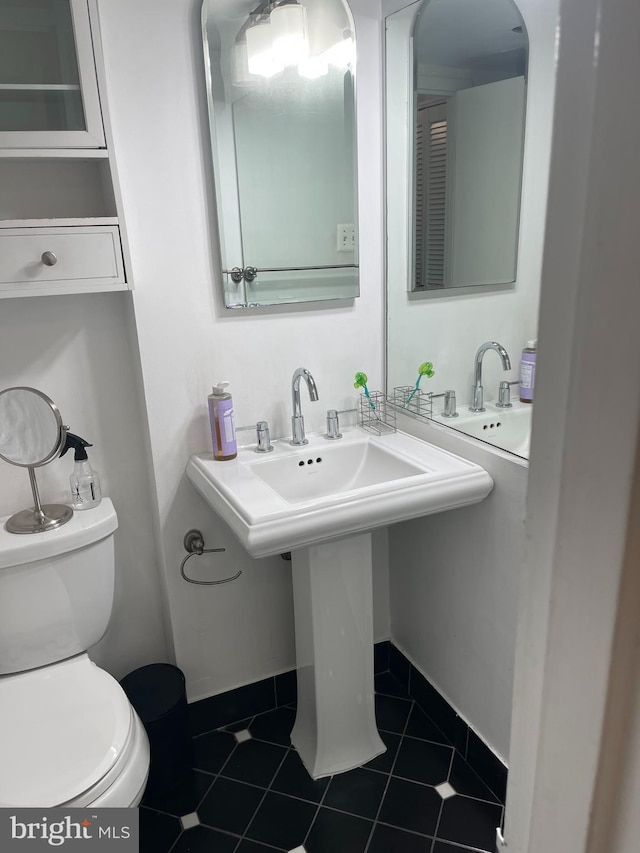 bathroom featuring toilet and tile patterned floors