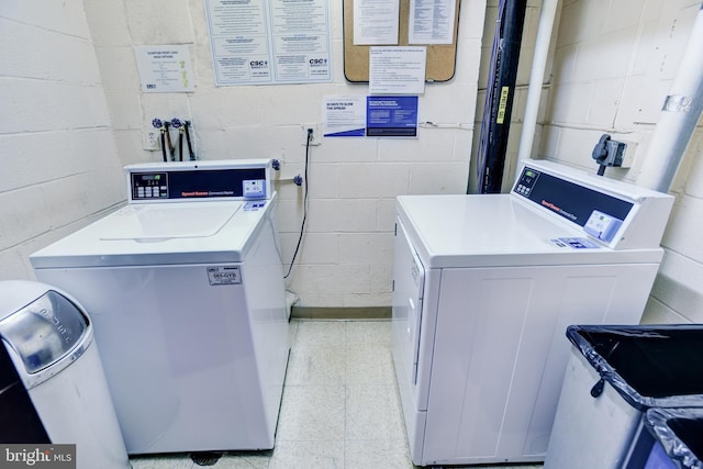 clothes washing area with separate washer and dryer