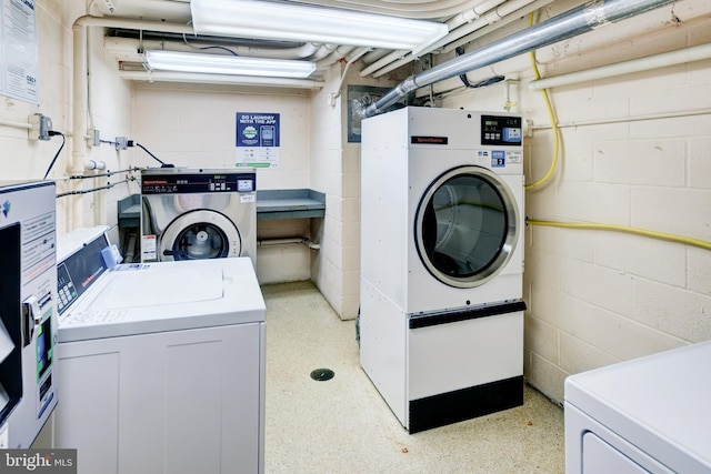 clothes washing area featuring separate washer and dryer