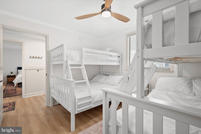 bedroom with ceiling fan, light hardwood / wood-style flooring, and crown molding