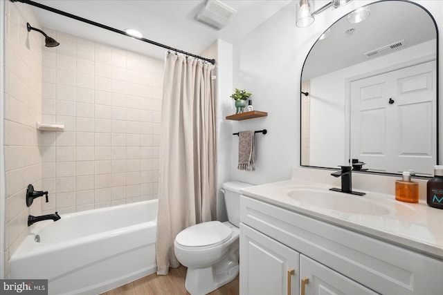 full bathroom with hardwood / wood-style flooring, toilet, shower / bathtub combination with curtain, and vanity