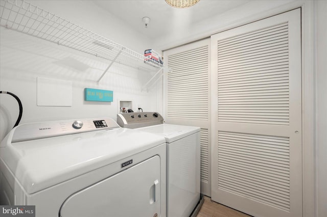 washroom featuring independent washer and dryer and light wood-type flooring