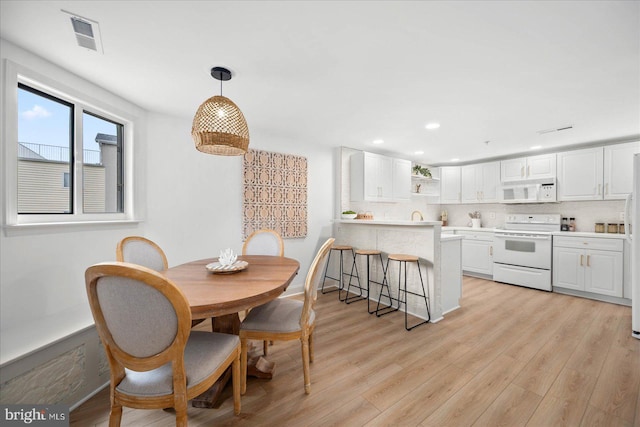 dining space featuring light wood-type flooring