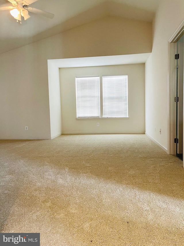 carpeted empty room with lofted ceiling and ceiling fan