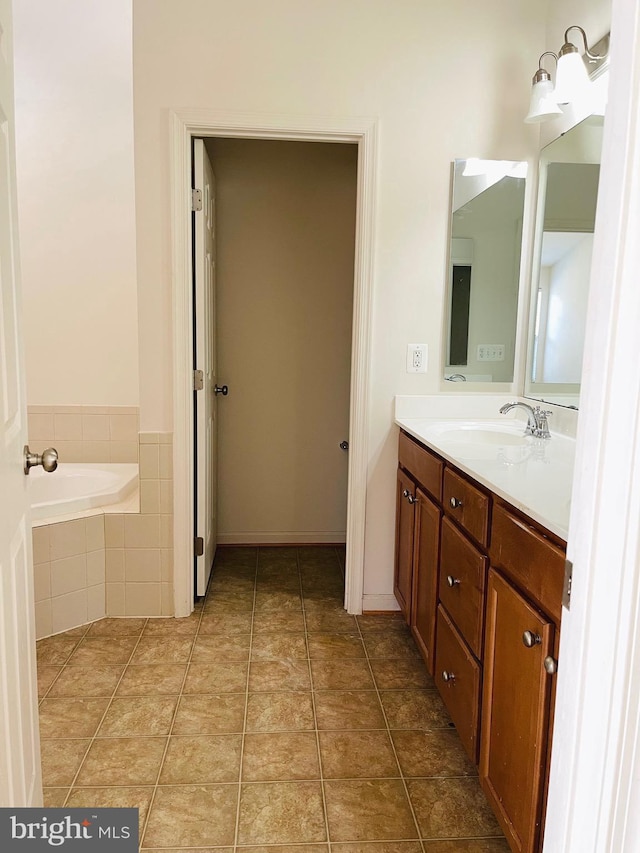 bathroom with vanity and a relaxing tiled tub